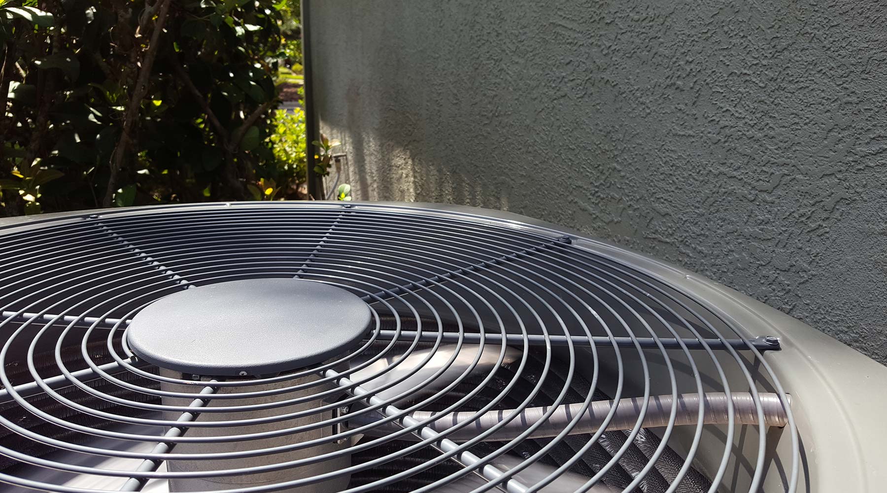 overhead view of air conditioner unit outside next to house