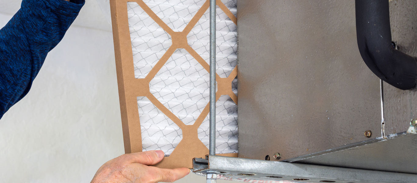 man replacing MERV rating air filter from HVAC unit