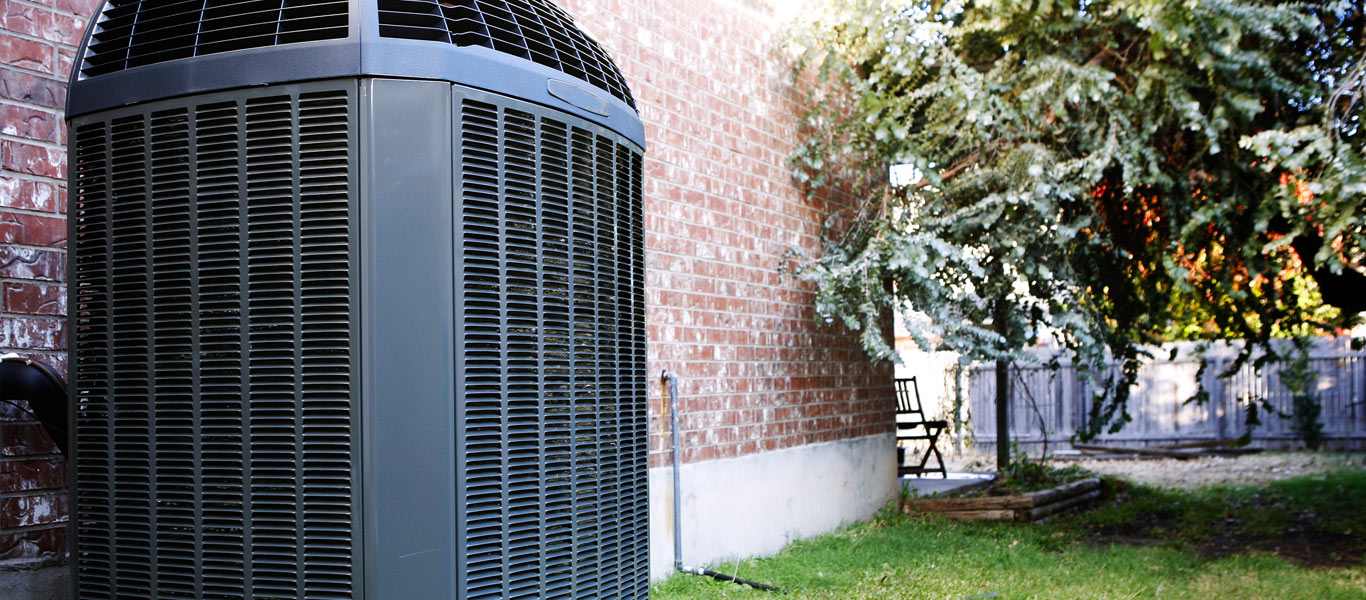 air conditioner compressor and condenser outside of brick home