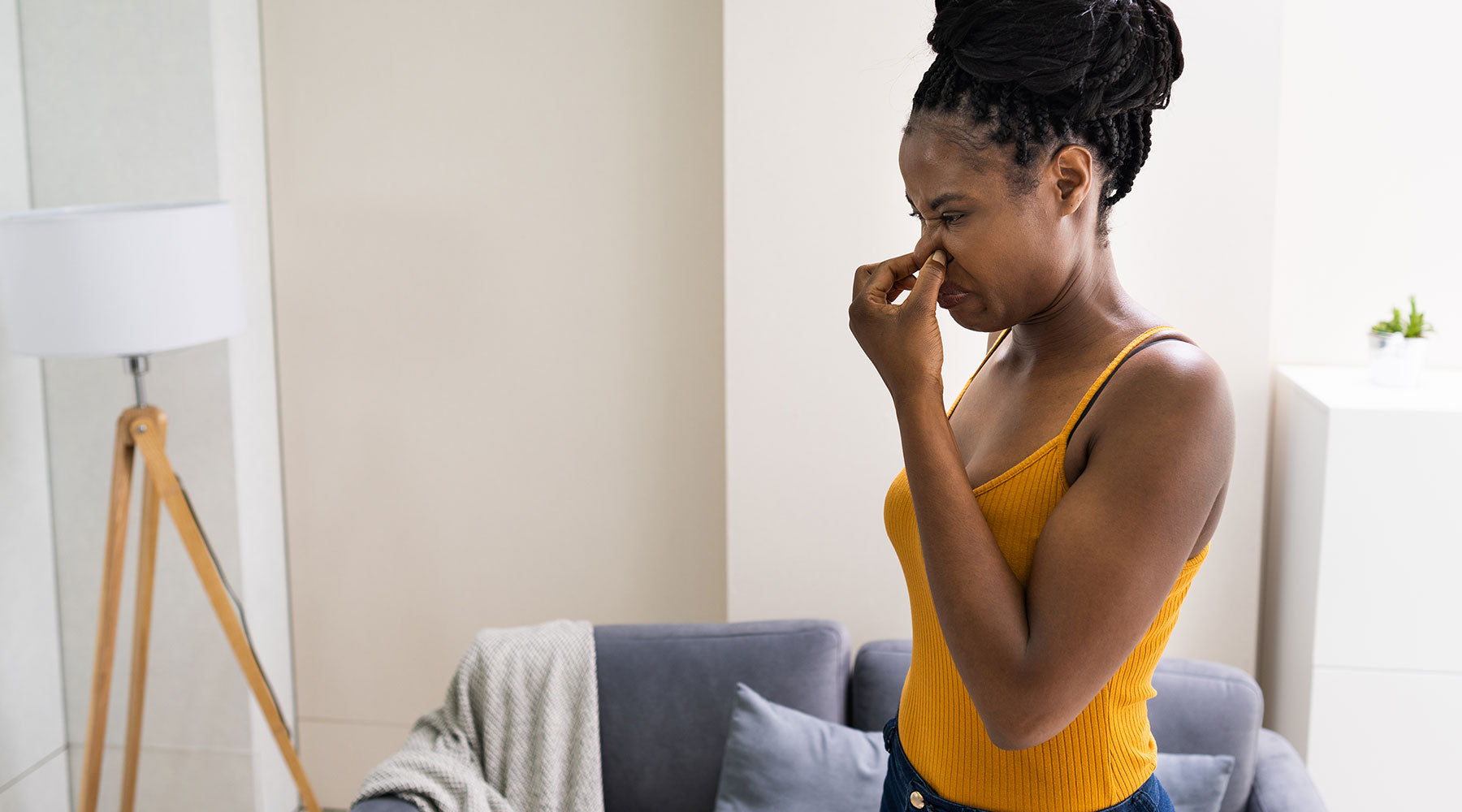 african american woman smelling freon from air conditioner leak