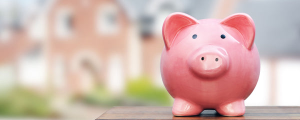 HEEHRA rebate program savings piggy bank with blurry house in background