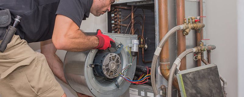 HVAC professional replacing furnace ECM blower motor