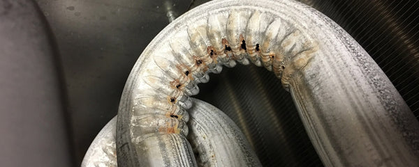 close up of furnace heat exchanger with holes