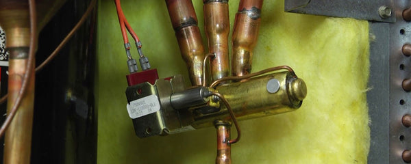 closeup of heat pump reversing valve