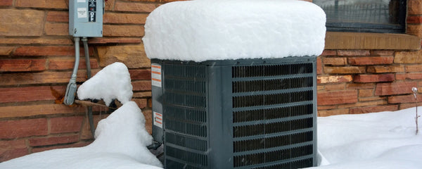 heat pump in cold climate with snow surrounding the outdoor condenser