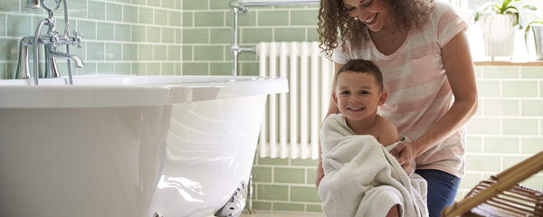 hydronic heating system installed in bathroom with child and mother
